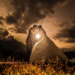 A classic silhouette of a couple sharing a kiss against a dramatic, cloudy sunset. Using a single light source, I created this powerful and romantic image that is perfect for a save-the-date or fine-art print.