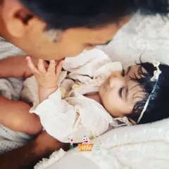 A tender moment between a father and his daughter. These quiet, gentle interactions are just as powerful as the big smiles. It's about capturing that feeling of safety and love.