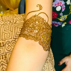 A beautiful arm band with a central floral motif and a trailing vine.