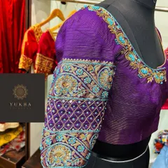 This is where my passion for detail comes to life. A custom bridal blouse in a rich purple, featuring intricate zardosi and threadwork with pops of turquoise, designed to be the statement piece of a bridal ensemble.