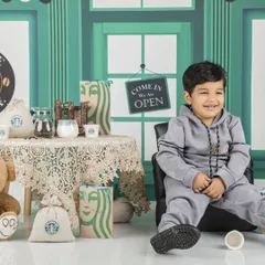 Welcome to baby's first Starbucks! This little guy is the coolest customer in his own mini coffee shop.