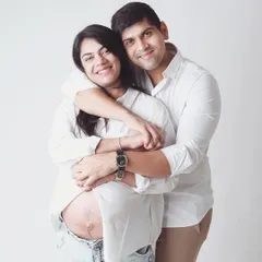 A casual and happy moment, with the mom to be's open shirt revealing the beautiful baby bump. It’s a celebration of your changing bodies and the life you've created together.