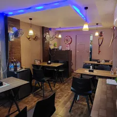 A look at our dining space before the evening rush. The wooden tables, simple chairs, and warm lighting are all chosen to create a comfortable and welcoming vibe.