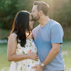There's something magical about a sunset session. Here, the golden light wraps around this beautiful couple, highlighting the tender kiss and the promise of their growing family. Outdoor maternity photography in a natural setting like this feels so timeless.