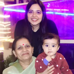 A three-generation family portrait, capturing a beautiful moment between a grandmother, mother, and her baby.