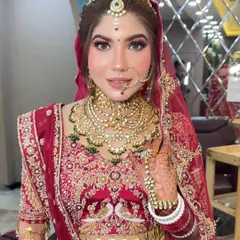 This bride wanted a "glass skin" look for her wedding day. I focused on creating a super dewy, reflective base with sharp, defined eyes and a neutral lip color to balance her ornate red lehenga.