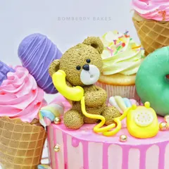 This candy-overloaded cake is a feast for the eyes, topped with a sweet fondant teddy bear chatting on a retro telephone. My workshops cover creating these charming, textured figurines.