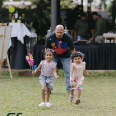 A father playing with his two young daughters on our spacious lawn. There's plenty of room for kids to run around.