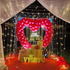 Our signature romantic cabana is perfect for an unforgettable surprise. It features a canopy of fairy lights, a red carpet walkway, and a stunning heart-shaped arch made of red balloons.