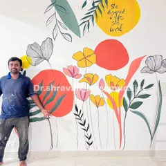 "She designed a life she loved." This boho foliage mural incorporates an inspirational quote, blending colorful abstract shapes with delicate floral line art for a truly personal touch.