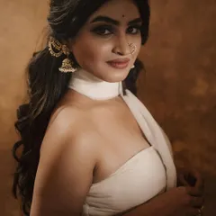 This look, created for a photoshoot, features a bold winged liner, a traditional nose ring, and soft waves, resulting in a modern yet classic aesthetic.