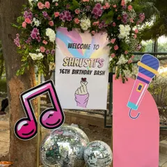 A welcome sign for a K-Pop themed 16th birthday. The sign features a microphone, a music note, and the iconic "finger heart" gesture, setting the tone for a music-filled celebration.