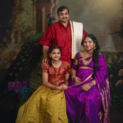 A complete family portrait in the Raja Ravi Varma style. The composition is carefully arranged to reflect classical portraiture, celebrating the family's bond and the anticipation of a new member.