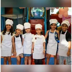 A team of little bakers! It's wonderful to see them working together, dressed in their chef outfits, ready to embark on a sweet culinary adventure.