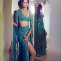 A fully sequined teal lehenga with a dramatic cape sleeve is a guaranteed head-turner. Let's work together to create your own version of this showstopping look.