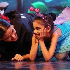 A quiet moment of connection amidst the energy of a stage performance. For me, teaching ballet is about building trust and sharing the joy of dance, one-on-one. This image captures the supportive bond I share with my young students.