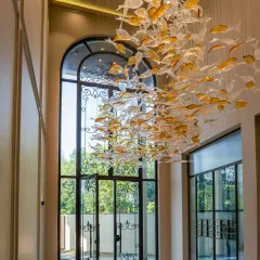 The entrance of our Sultanpur farmhouse sets a tone of neo-classical elegance. The custom-designed fish chandelier is a floating sculpture in the double-height foyer, welcoming you into a space where every detail is a piece of art.