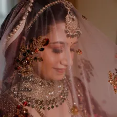 A beautiful close-up of the bride through her veil. The intricate embroidery and her gentle smile create a portrait that is both delicate and full of emotion.