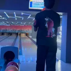 A player lines up their shot during a league match. The neon lights and energetic atmosphere make every frame an experience.
