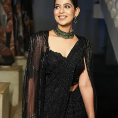 Dressed in a stunning black sequin saree with a modern cape. This look was for the Encalm annual event, blending traditional grace with contemporary fashion.