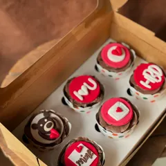 Say "I love you" with a box of sweet treats. These chocolate cupcakes are decorated with cute, romantic fondant messages and shapes, perfect for anniversaries, birthdays, or just because.