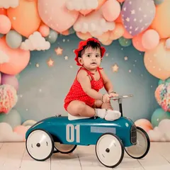A dreamy setup for a little doll. We use colorful backdrops and fun props like this vintage toy car to bring your child's imagination to life in the studio.