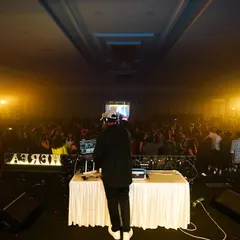 Looking out at a sea of people from my DJ booth. Handling large crowds and keeping the energy high from start to finish is what I do best.