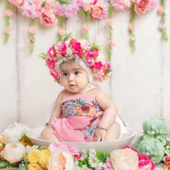 A little doll in a floral paradise. This 'milk bath' style shoot with flowers is a beautiful and unique way to capture a baby's portrait.