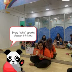 During our story sessions, every "why" from a child is an opportunity. It sparks deeper thinking and encourages a curious mindset. Here, an instructor engages with the children, fostering a dialogue around the story.