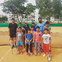A group photo with some of my students on the clay court. Our group coaching sessions allow players to learn in a dynamic environment, ready with their tennis rackets for the next drill.