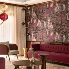 We believe in fearless design, as shown in this living room from our 'Tinted Tapestries' project. A rich plum velvet sofa is set against a dramatic, hand-painted wallpaper, balanced by sculptural lighting and tables to create a space that is both maximalist and meticulously curated.