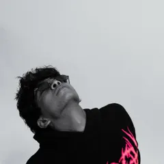 A dramatic black and white shot of an artist, showcasing the creative potential of simple lighting and a clean background.