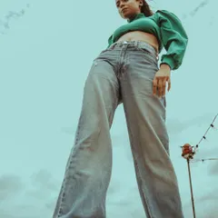 The low angle creates a powerful, heroic silhouette. This technique is great for making a strong fashion statement in an ad campaign or editorial.