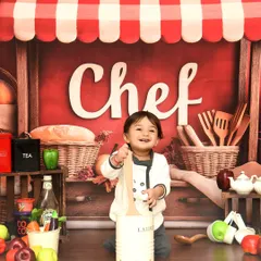 A close-up of our happy little chef. His infectious smile shows just how much fun a themed photoshoot can be.