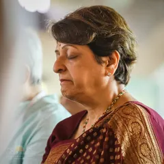 A participant in a state of serene meditation during a Homa ceremony. Our programs create an environment where you can easily let go of thoughts and experience deep inner peace.