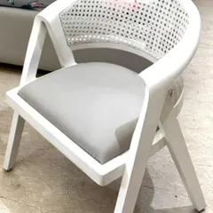 Add a touch of elegance to your bedroom with this beautiful chair. It features a white-finished wooden frame and a gracefully curved back with cane webbing. The wood color and fabric are fully customizable.