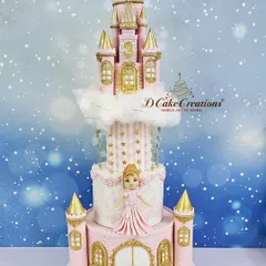 A full shot of the grand four-tier castle cake, complete with hanging stars and a cloud effect, making it a true fairytale creation.