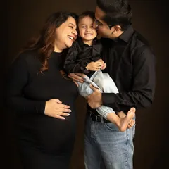 A moment of pure, unscripted joy. The best family portraits happen when you forget the camera is even there. Here, a candid laugh makes for a perfect memory.