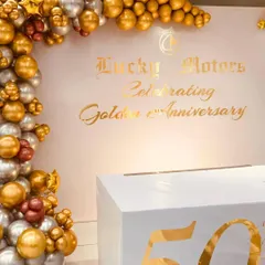 We helped Lucky Motors celebrate their Golden 50th Anniversary with this clean and elegant photo backdrop. The design uses a chrome gold and silver balloon arch to frame the custom gold-foil branding, creating a professional and high-end look for their corporate event.