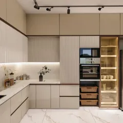 A beautiful and functional modular kitchen design featuring beige and fluted panel cabinets, a tall unit for appliances, and a glass-door crockery display.