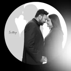 A creative black and white portrait using a circular frame and shadow play. This artistic shot tells a story of love and unity, with the couple's shadows forming a heart.