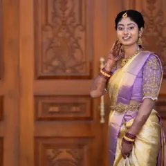 A beautiful, candid moment from a photoshoot. The makeup was kept elegant and understated to match the soft lavender and gold saree, with an emphasis on clean skin and defined eyes.