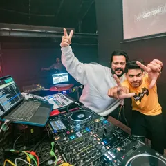 Posing with a fellow artist at the New Year's 2023 party. A moment of celebration behind the decks.