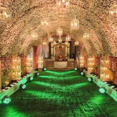 Step into blossom bliss with this cherry blossom entrance tunnel. The entire arched passage is covered in artificial pink and white cherry blossoms, with birdcage lanterns hanging from within. This creates a beautiful, immersive floral experience, perfect for a romantic evening event.
