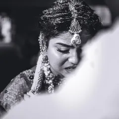 An emotional close-up of the bride during a poignant moment in the ceremony. Black and white photography strips away distractions, focusing purely on the feeling.