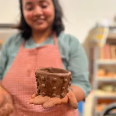 A participant from the Teach for India team building retreat proudly displays the textured pot she made. It is so rewarding to see the unique character each person brings to their creation.