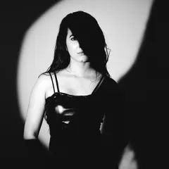 Black and white photography strips away everything but the essential. Here, I used a focused spotlight to play with shadow and light, creating a mysterious and captivating portrait that feels timeless.