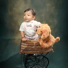 So handsome with his little bow tie and furry friend. Using props like this vintage-style cart adds so much character to toddler photoshoots.