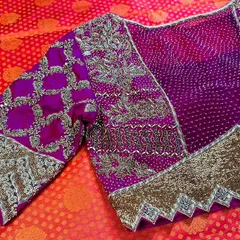 A truly royal creation for a special client. This magenta blouse is a showcase of heavy craftsmanship, featuring intricate zari and beadwork on a traditional bandhani base, with unique scalloped sleeve cuffs for a regal finish.