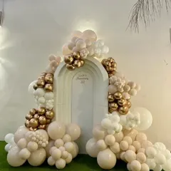 Celebrating a 33rd anniversary with class. This elegant backdrop features a white arch adorned with a beautiful garland of champagne, white, and gold chrome balloons.